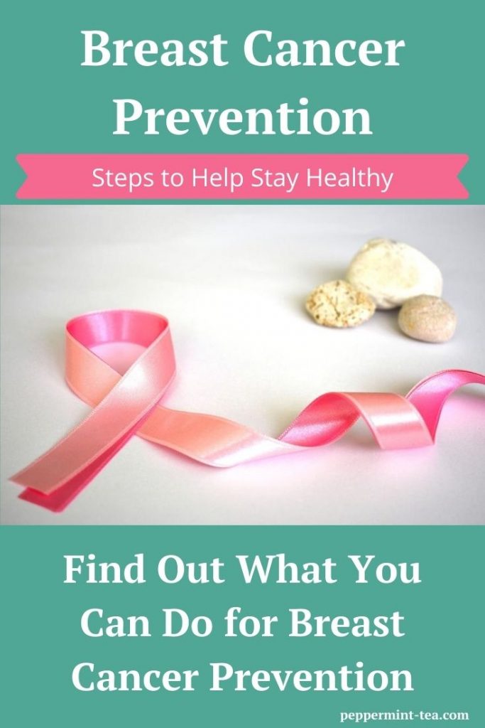 Photo of pink ribbon beside stones for breast cancer prevention