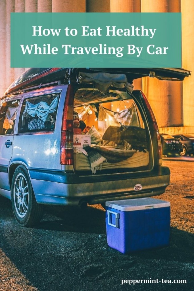Photo of car with cooler sitting beside it as example of how to eat healthy while traveling