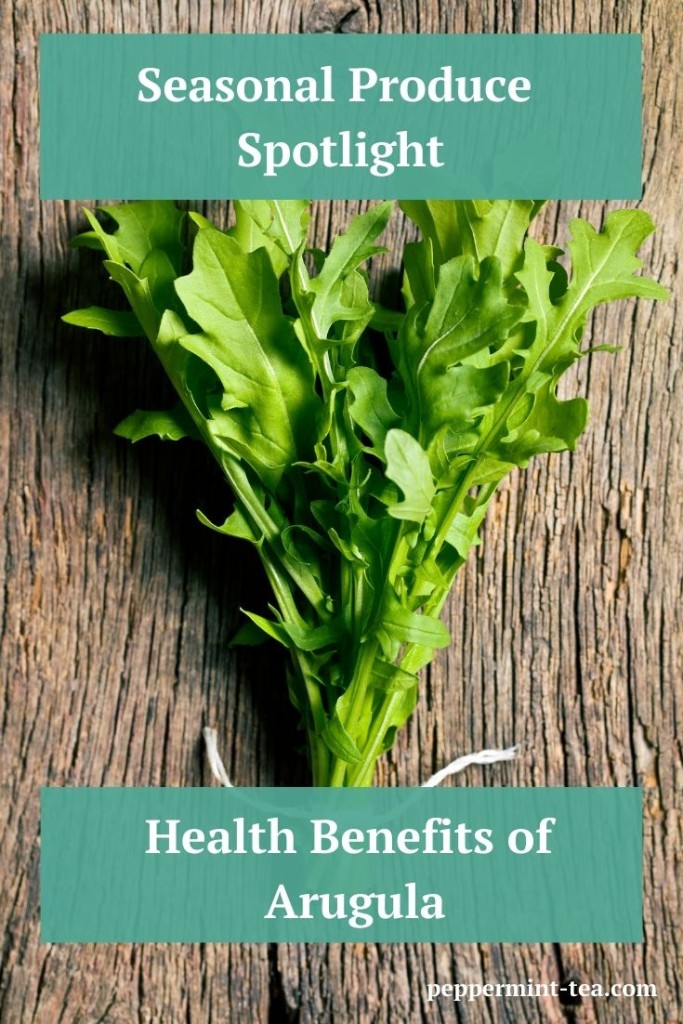 Photo of arugula lying on a piece of wood as an example of the health benefits of arugula.